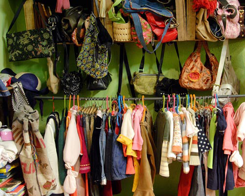 Ropa de niño y bolsos dispuestos en la tienda. Por Ábrete Sésamo